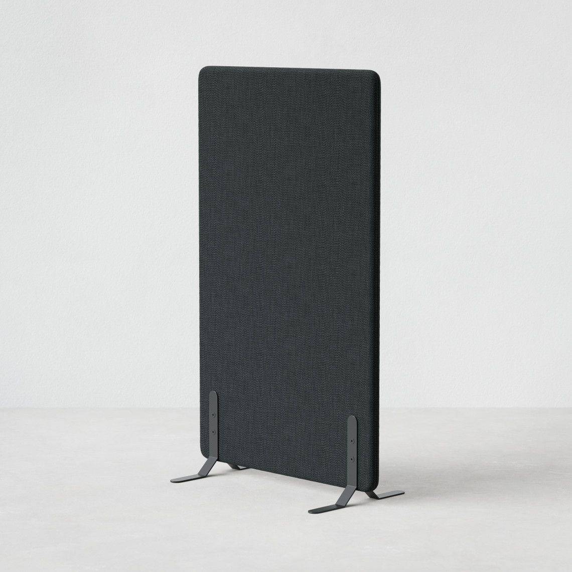 Ljudabsorberande golvskärm i svart klädsel utrustad med svarta skärmfötter, snett från sidan. Ljudabsorberande golvskärm i svart klädsel utrustad med svarta skärmfötter, snett från sidan.